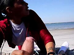 Ebony beauty sucks white cock on beach