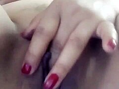 Pornstar teases her wet pussy with hands.