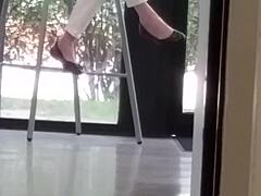 mature woman engages in shoe play with feet and shoes