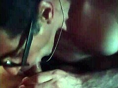 guy sucking cock with ice in mouth while getting crossed handjob in gay oral scene