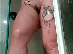 Fit brunette filmed herself showering and showing off her tattoos