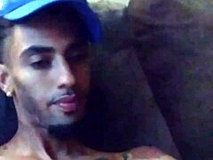 Tattooed woman masturbates suggestively in private scene.