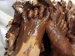 the goddess shows her petite feet covered in chocolate cream in the garage pov