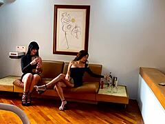 Latinas with big tits perform oral sex on the sofa