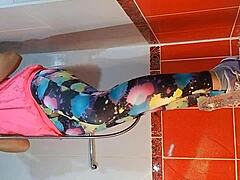 Babe with natural tits uses dildo for masturbation in gym shower, close up on tits and pee