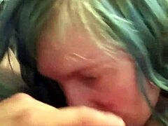A girl with blue hair gives a deep blow job