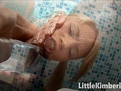 Young blonde girl masturbates with a dildo to achieve orgasm
