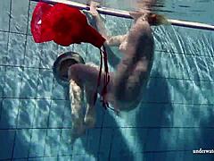 Russian Teen Lucie Swimming Underwater in Pool.