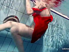 Russian Teen Lucie Swimming Underwater in Pool.