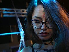 Tattoo girl in uniform and miniskirt at bdsm studio