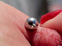 Close up of pierced nipples on a hot European milf on the balcony
