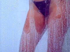 college tanned gorgeous girl feels relaxed taking a shower in her bikini