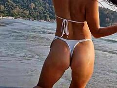 Ever seen a cute girl flashing her white bikini on the beach like this?