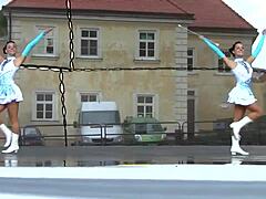 Two nice majorettes performing in their cheerleader outfits