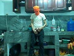 this 25-year-old guy with a big flaccid penis starts masturbating in the kitchen while waiting for his best friend to arrive