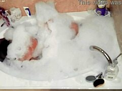 In the bathroom, this boy takes a solo bubble bath, focusing on his feet and bare body in a casual homemade video.