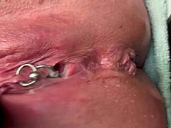 Why is this pierced clit getting rubbed hard in latex gloves before a strong pee stream?