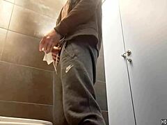 Sexy bodybuilder jerks monster cock in risky public bathroom spot