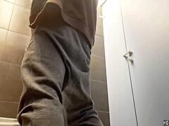 Sexy bodybuilder jerks monster cock in risky public bathroom spot