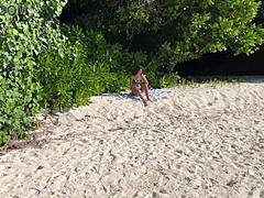 A shocked skinny babe in lingerie gets pissed on her oiled wet pussy at public beach pov