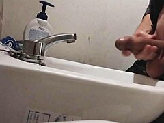 skinny dude rests huge balls on sink preps monster cock for massive cumshot