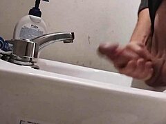 skinny dude rests huge balls on sink preps monster cock for massive cumshot